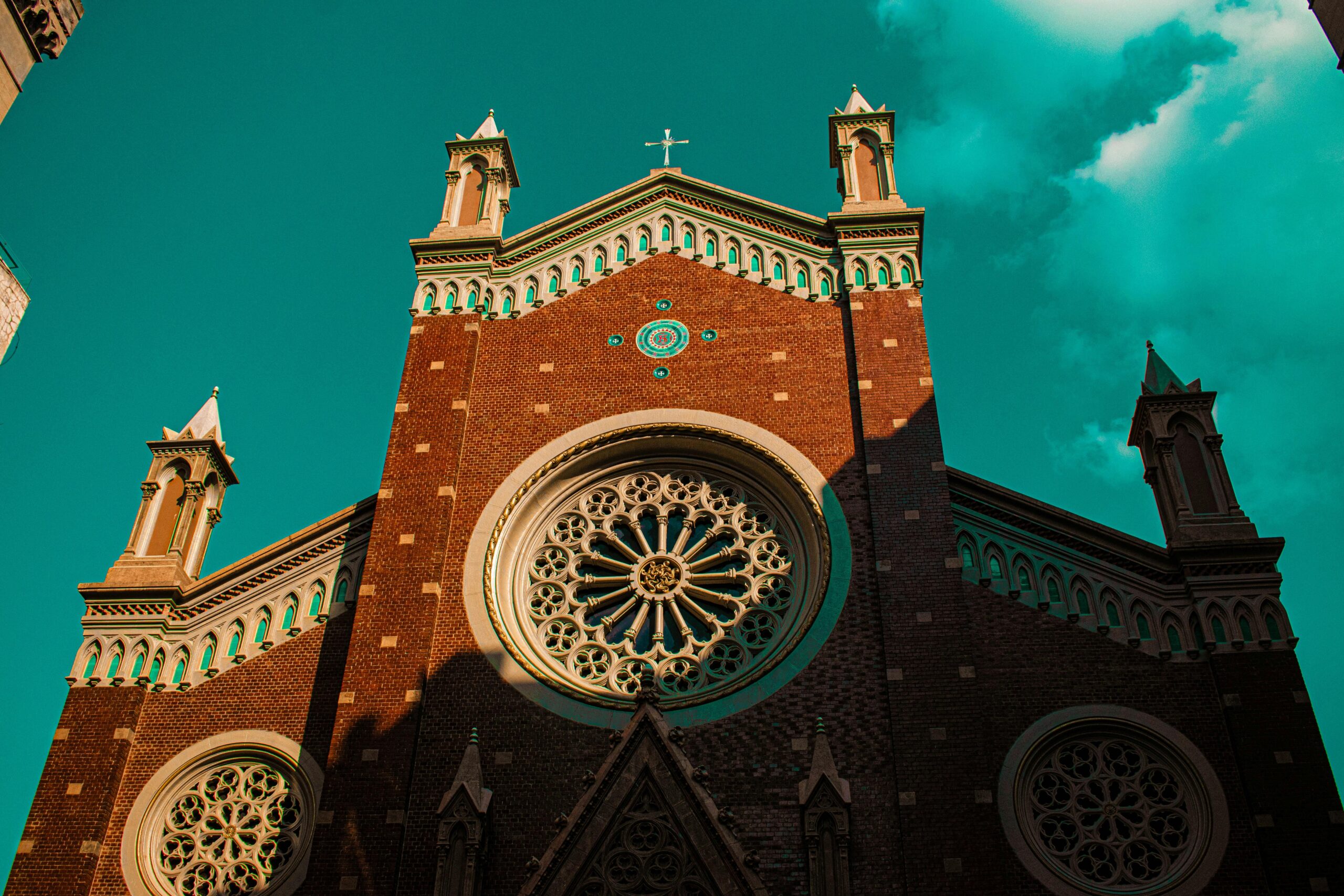 Low angle shot of St. Anthony of Padua Church's facade in Istanbul under a vibrant sky.